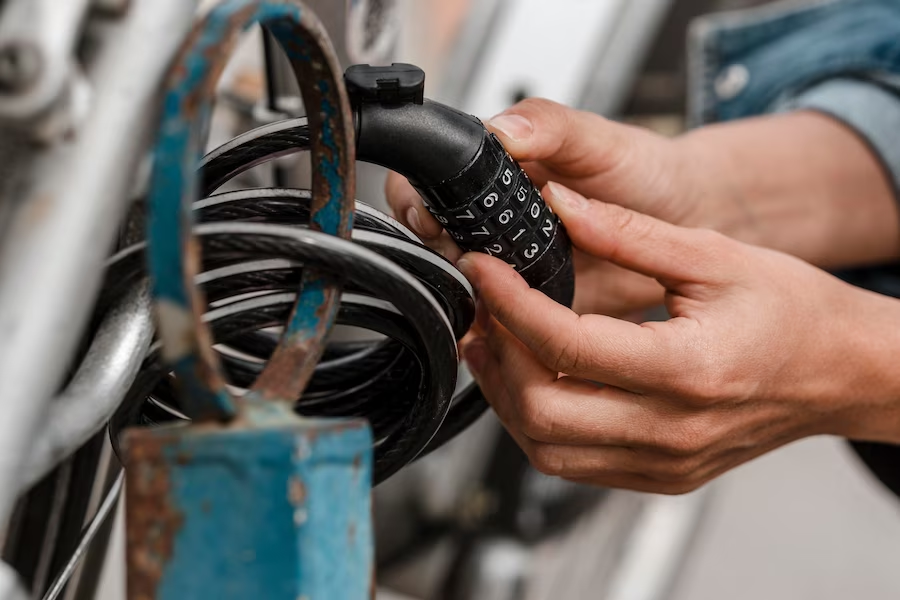 Hand grasping a combination lock requiring a numeric code