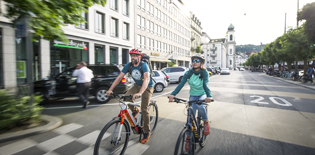 Man and woman riding a bicycle on the city road