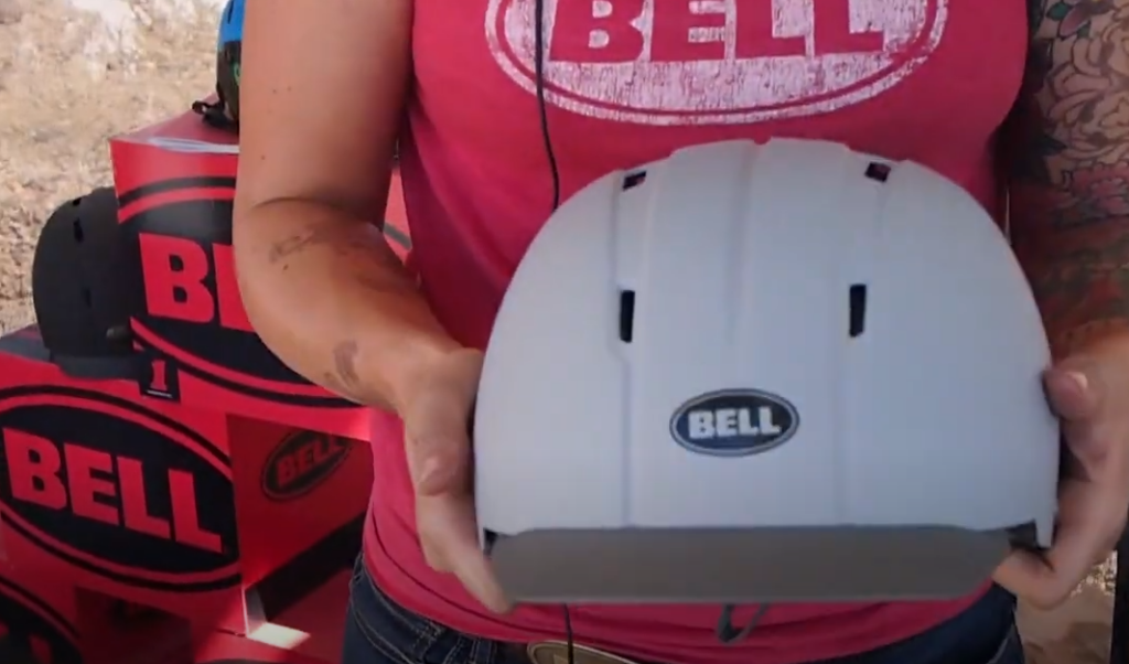 Person holding a gray bell helmet