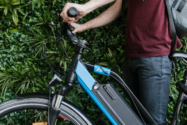 A man is standing near a bicycle