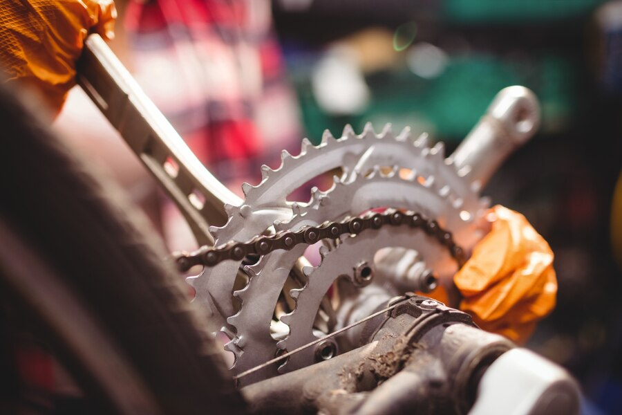 person repairing a bicycle, camera focused on the chain