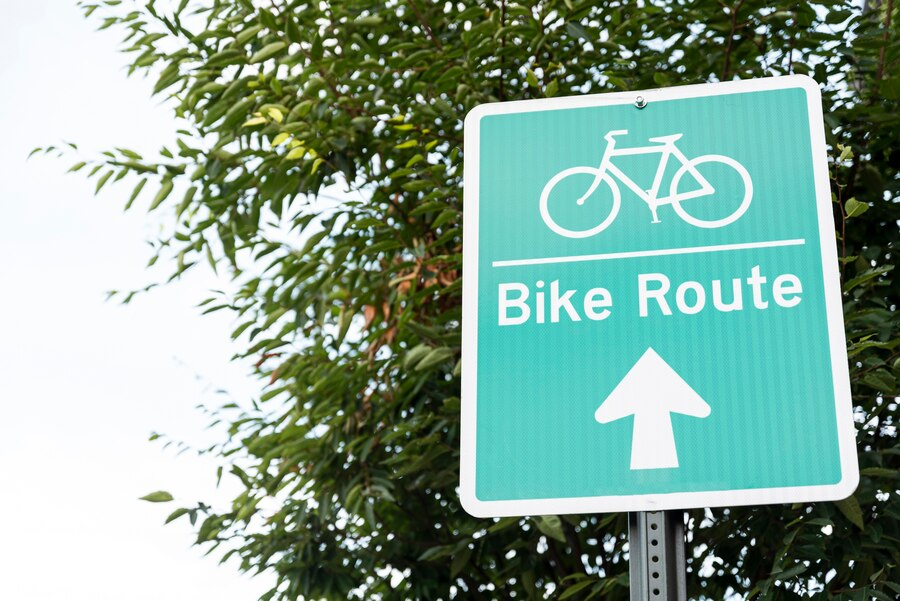 Close-up photo of a bicycle sign with a tree in the background