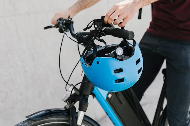 Person biking with a helmet attached to the front