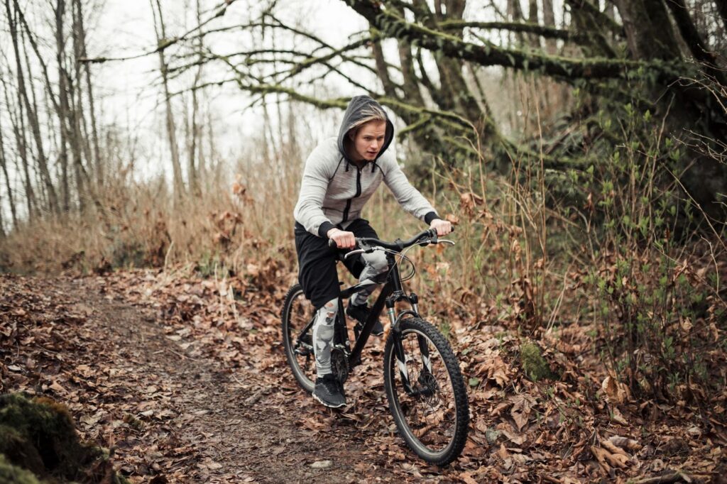 Cyclist riding bicycle in the forest